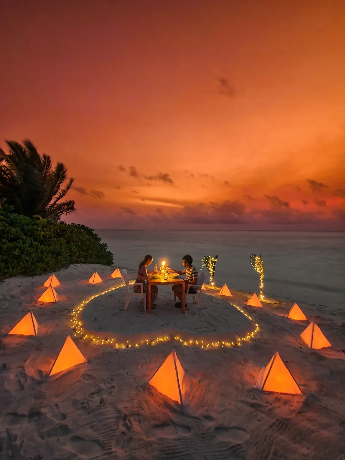 A romantic dinner on the beach at sunset